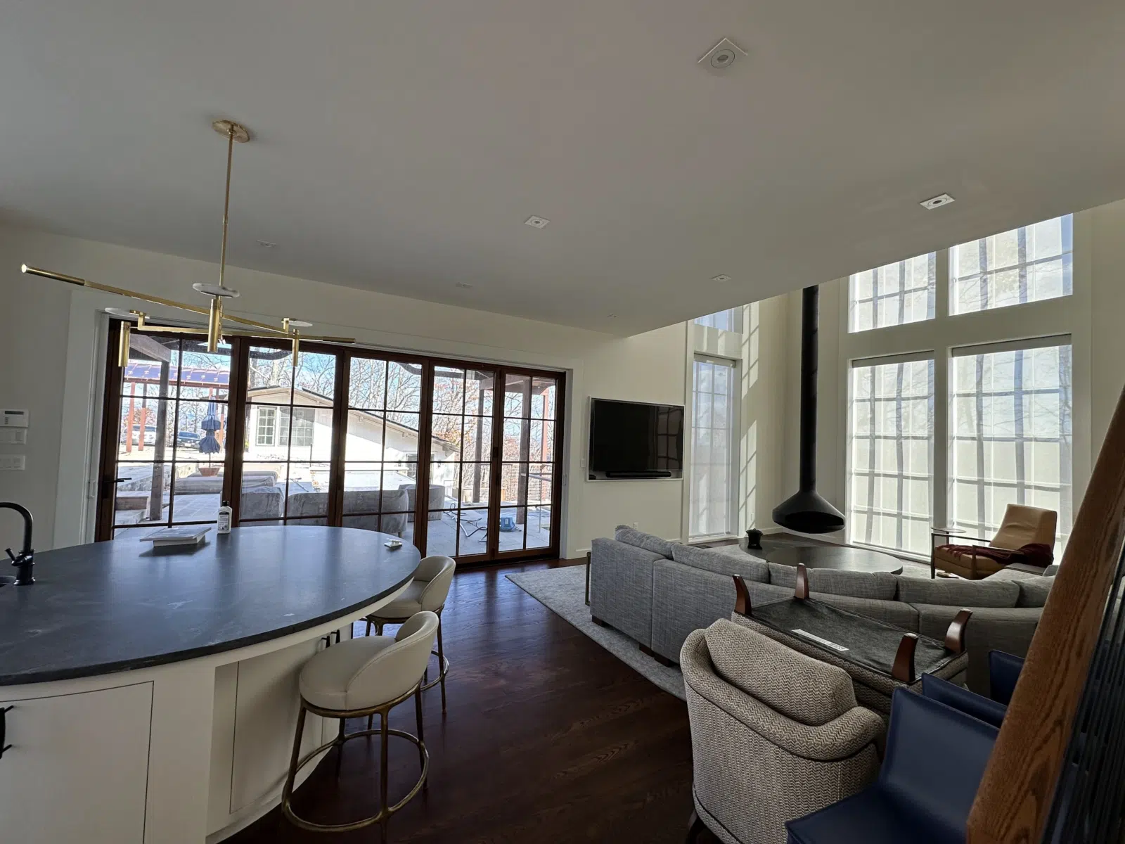 Open-plan living room and kitchen with tall windows — Alvarez' Painting in Charlottesville